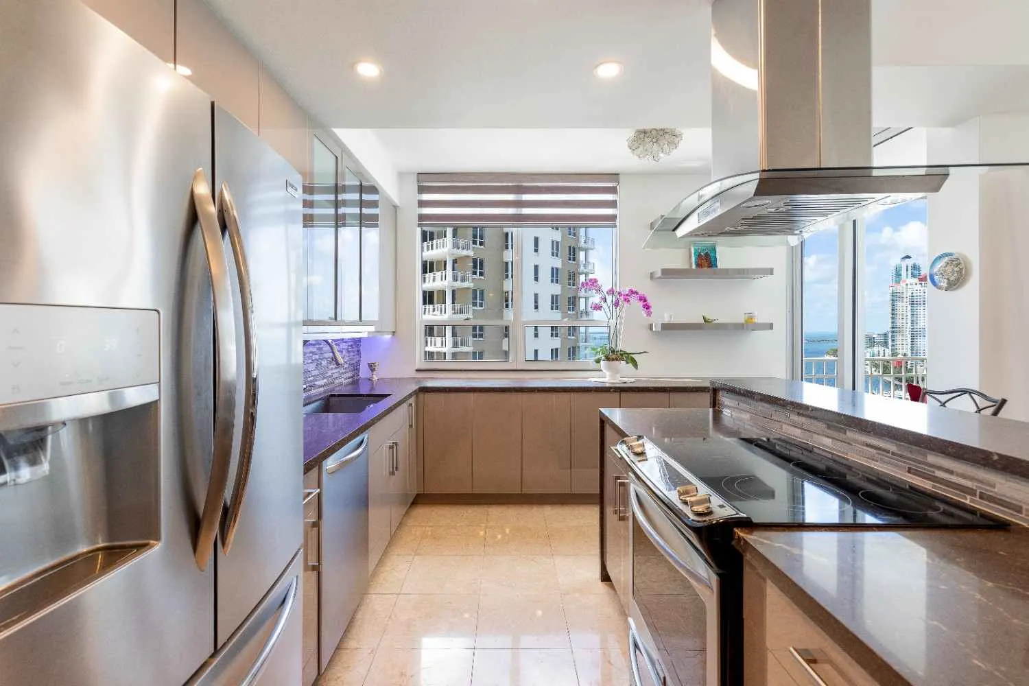 Kitchen with stainless refrigerator and range